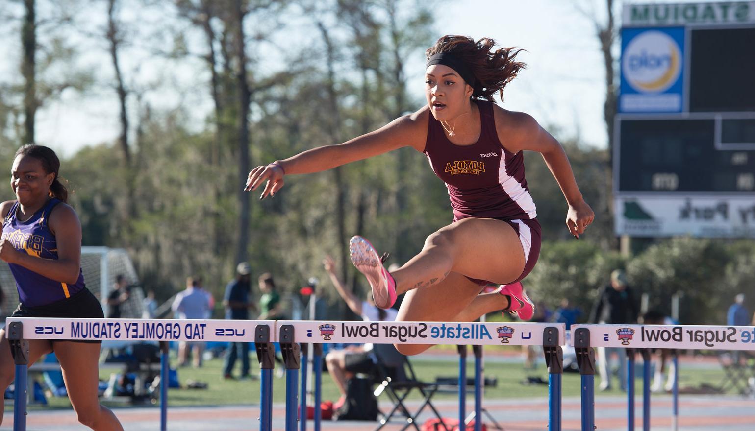 Student athlete completing hurdles